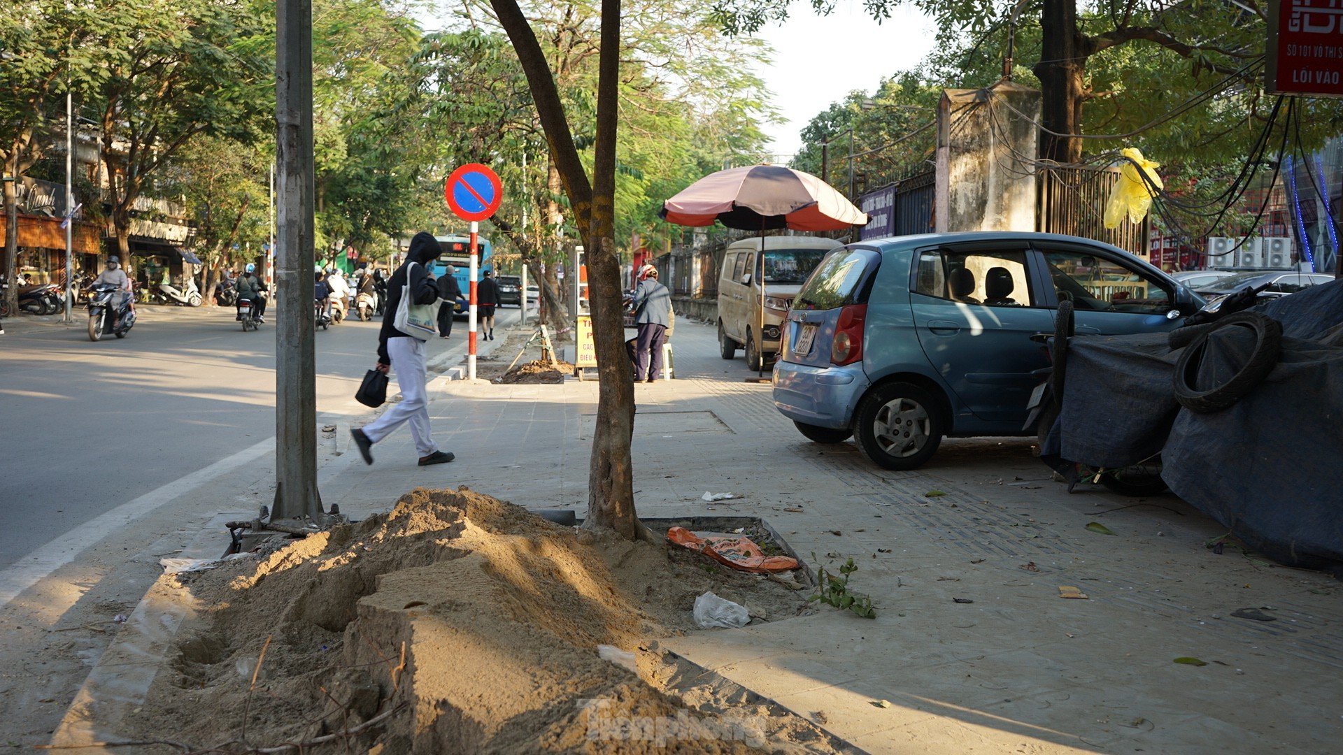 Sidewalks not yet dry but already 'shredded' by cars and motorbikes photo 6