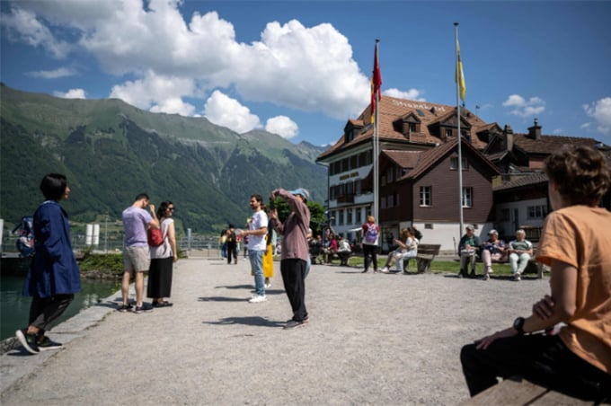 Asian tourists flock to the village. Photo: AFP