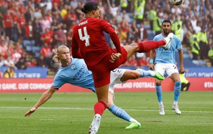 Van Dijk (red) blocks Haaland's shot in the Community Shield earlier this season. Photo: Action Images.