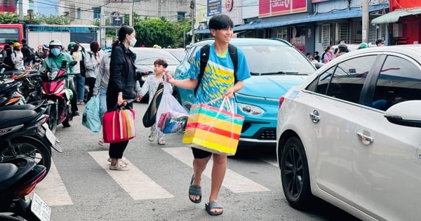 Die Menschen kehren nach dem Feiertag mit Taschen in der Hand nach Ho-Chi-Minh-Stadt zurück