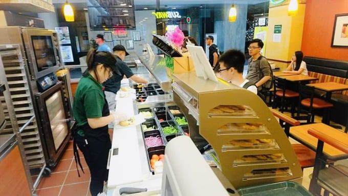 Vietnamese students work part-time at a bakery in Singapore. Photo: Dinh Hoang Ha