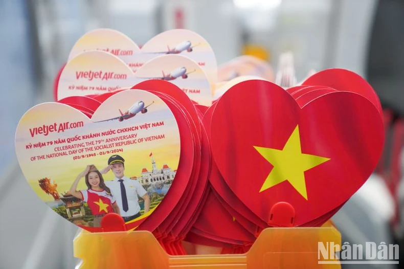 Brilliant red flags with yellow stars celebrate National Day September 2 on Vietjet flights photo 2