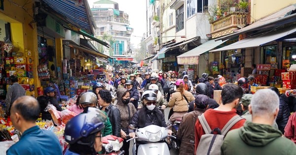 Hanoi Old Quarter is bustling with people shopping for Tet