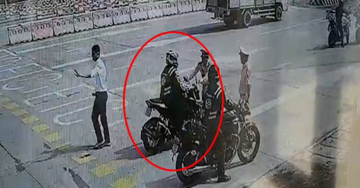 Clip of a large-displacement motorbike passing a toll booth and hitting a traffic police officer on the highway