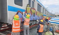 Cleaning graffiti on metro train No. 1 in HCMC