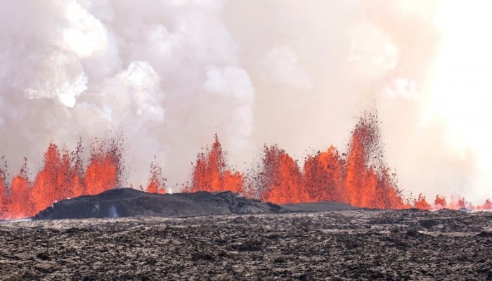 Iceland volcano erupts violently, lava flows to town's defensive walls