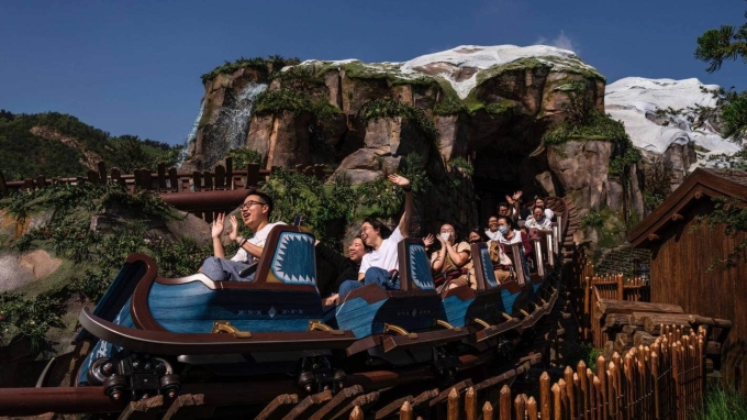 Visitors experience a new roller coaster in the World of Frozen park area. Photo: AP