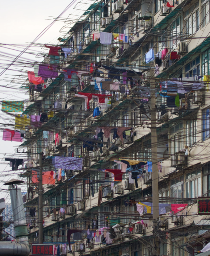 A clothes rack extends into the street at a high-rise apartment building in Shanghai in 2011. Photo: Reneby/VCG