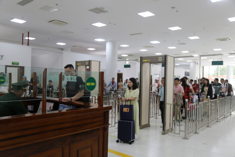 Tourists go through customs at the border gate.