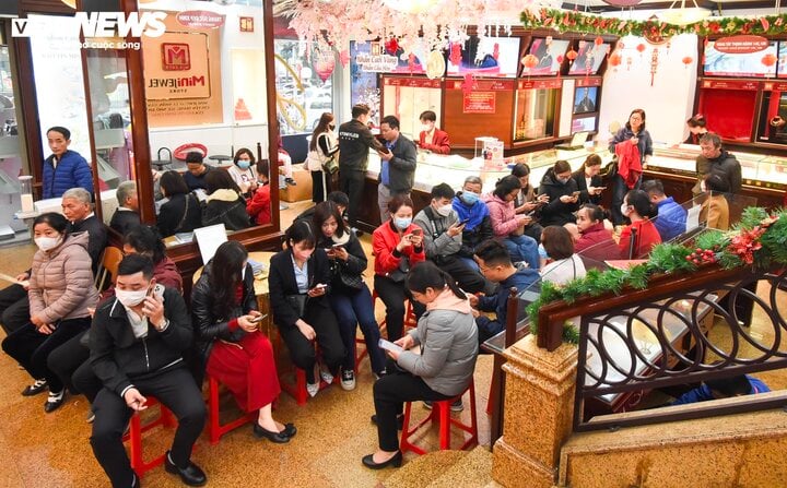 Inside large gold stores, customers are instructed to line up or sit and wait their turn.