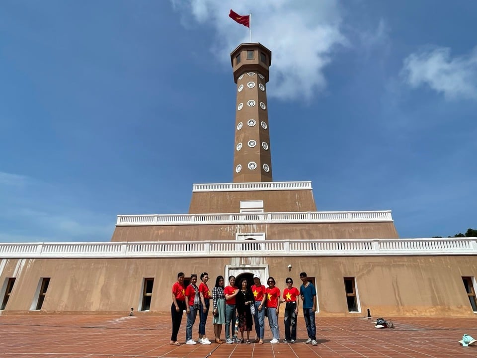 Tourists from the capital take souvenir photos at Hanoi Flag Tower in Ca Mau Cape (Hoang Nam)