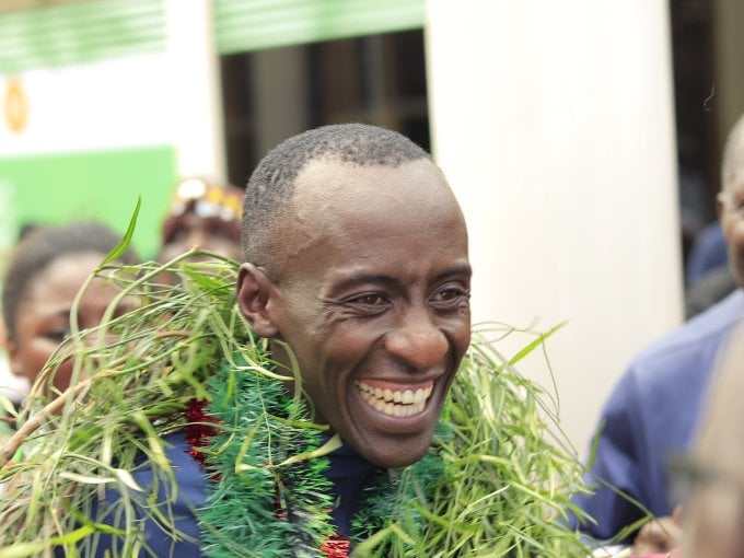 Kipchoge smiles as he is welcomed at Jomo Kenyatta Airport in Nairobi on October 10. Photo: Athletics Kenya