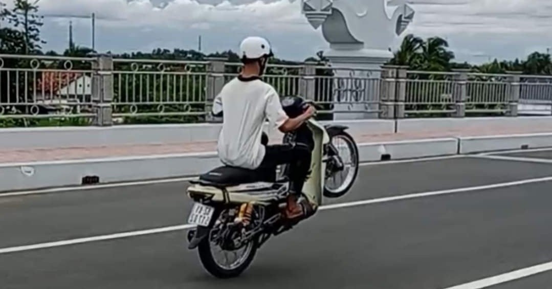 17-year-old boy wheelies motorbike, lets go of handlebars to film clip to post on social media