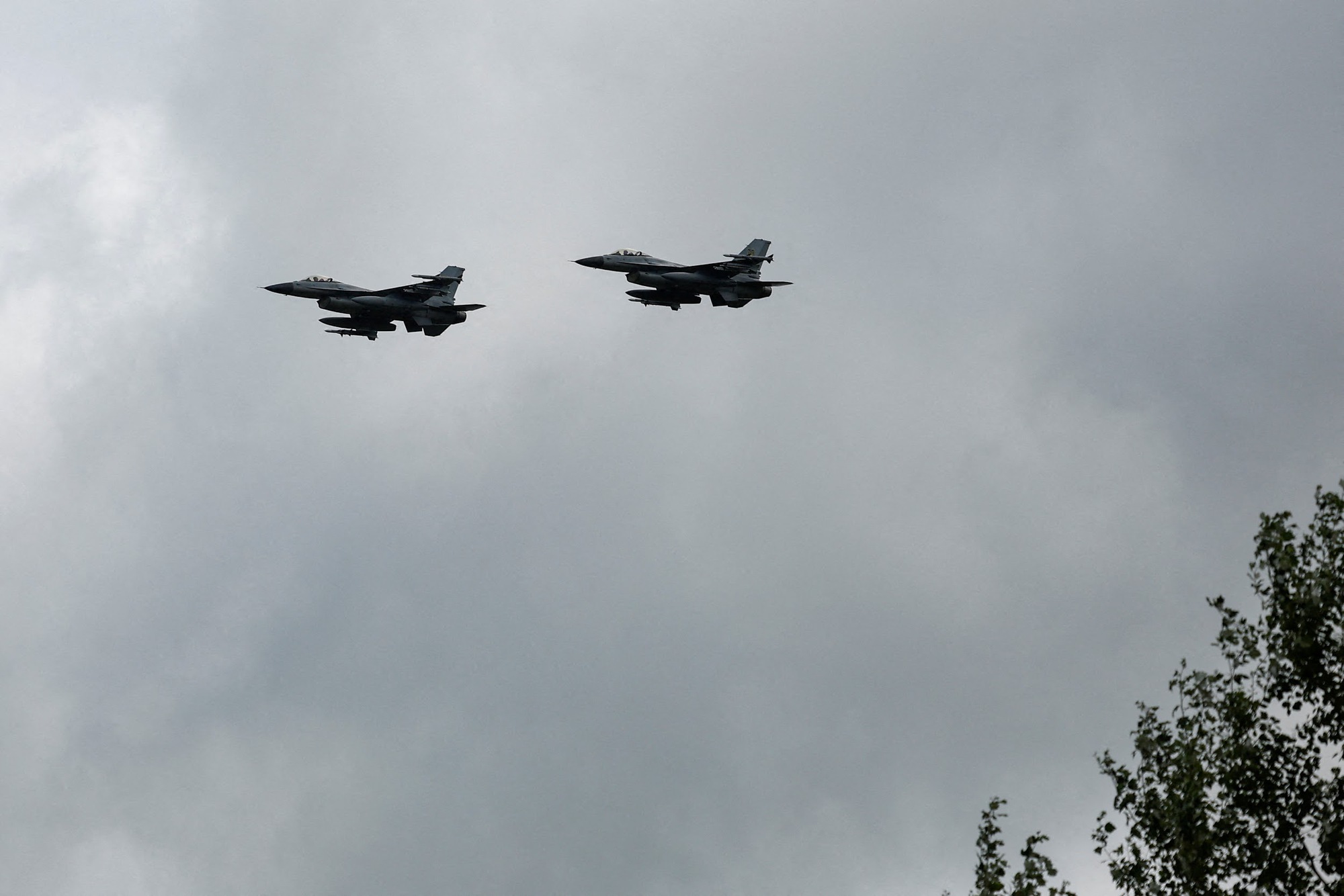 Ukrainian F-16 fighting aircrafts are seen in the air during marking the Day of the Ukrainian Air Forces in an undisclosed location in Ukraine