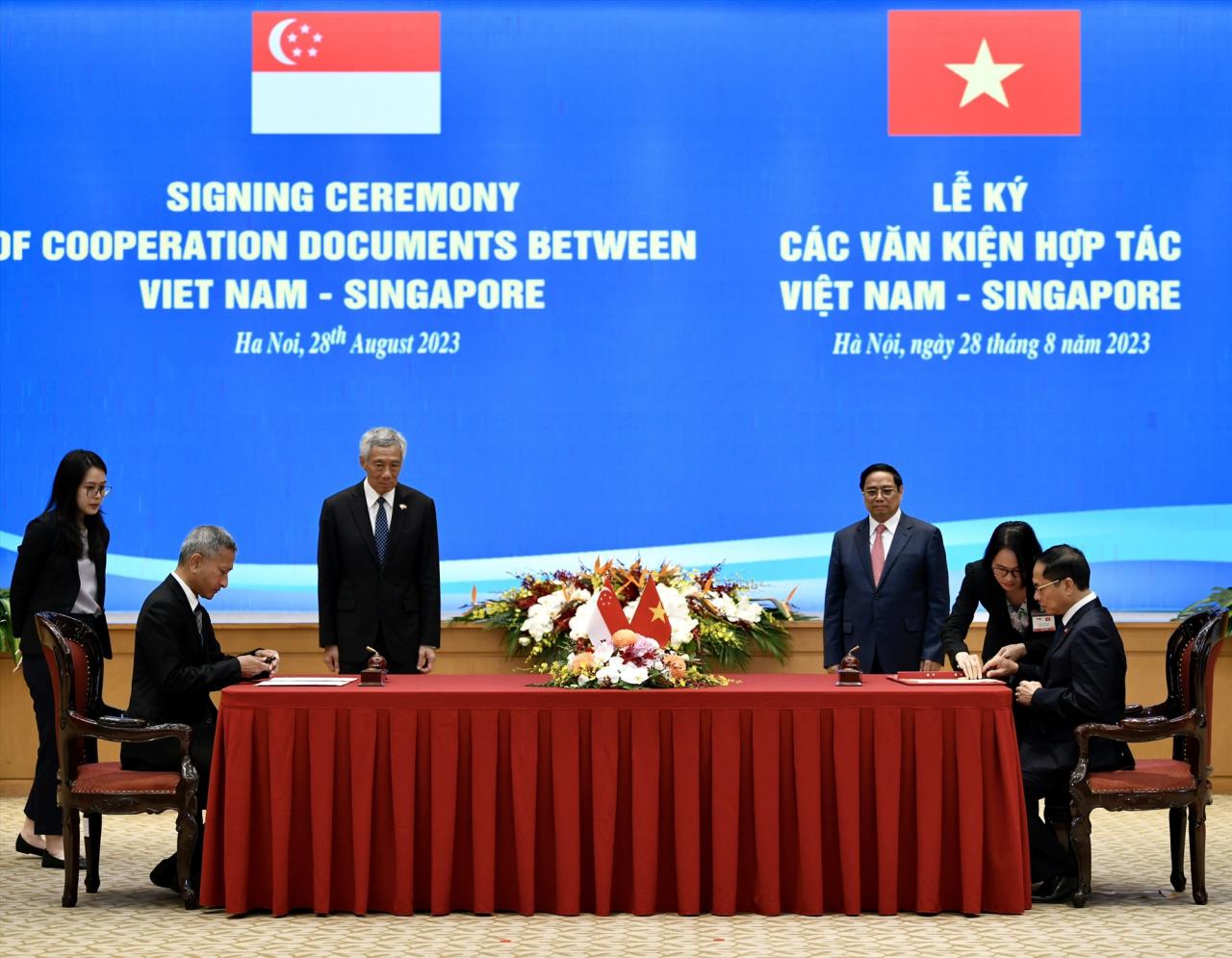 Le ministre des Affaires étrangères Bui Thanh Son (assis, à droite) et le ministre des Affaires étrangères de Singapour, Vivian Balakrishnan (assis, à gauche) signent un accord de coopération. Photo : Hai Nguyen