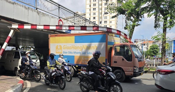 Truck stuck under Hoang Hoa Tham bridge in Ho Chi Minh City