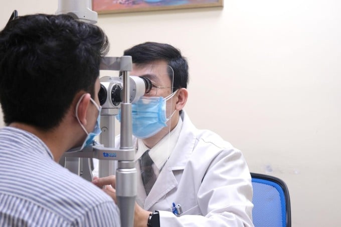 Doctor Tung examines a patient's eyes. Photo: Dinh Tien