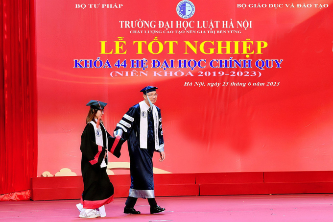 Hiệu trưởng trường Đại học Luật Hà Nội dắt tay Mai Anh lên sân khấu để tặng giấy khen. Ảnh: Gia đình cung cấp