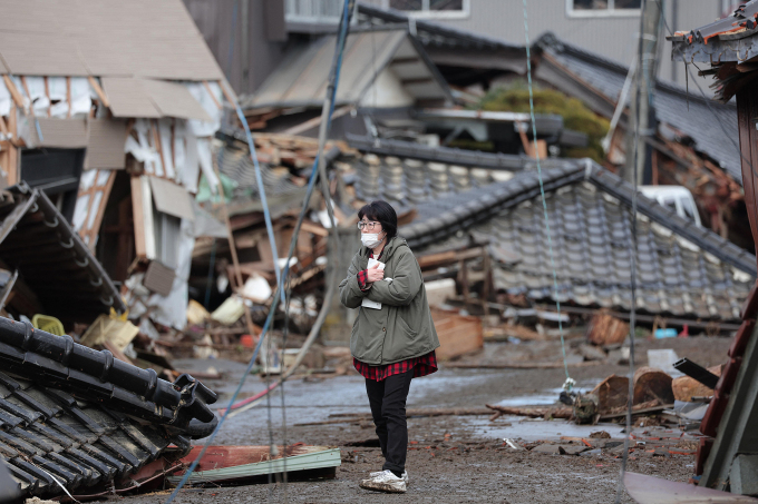 A woman returns to her house destroyed by the tsunami and earthquake in Suzu, Ishikawa Prefecture, June 2. Photo: AFP