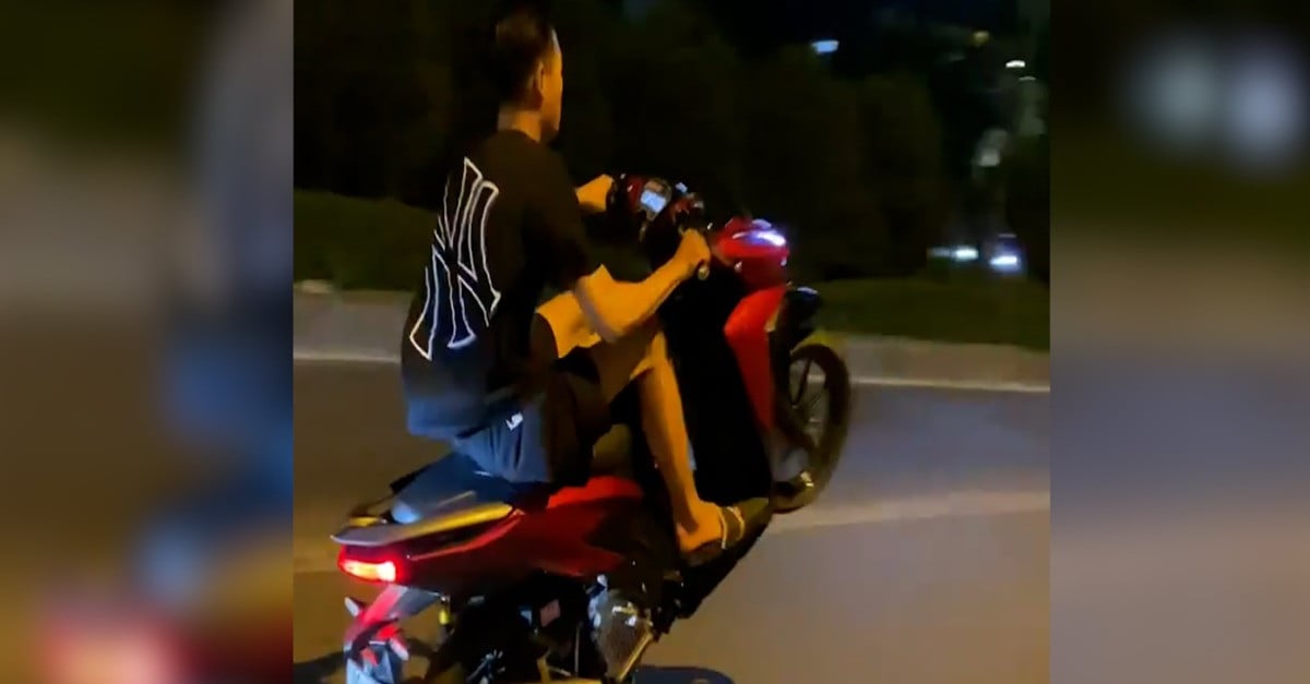 Young man doing a wheelie on motorbike in Hanoi receives 3 'fines' at the same time