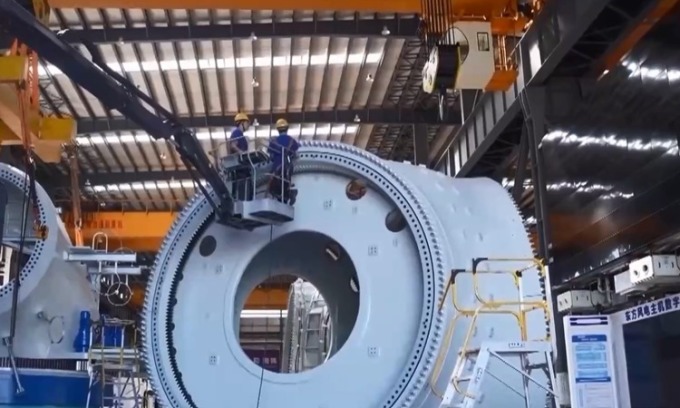 Workers inspect a key part of an 18 MW wind turbine. Photo: CMG