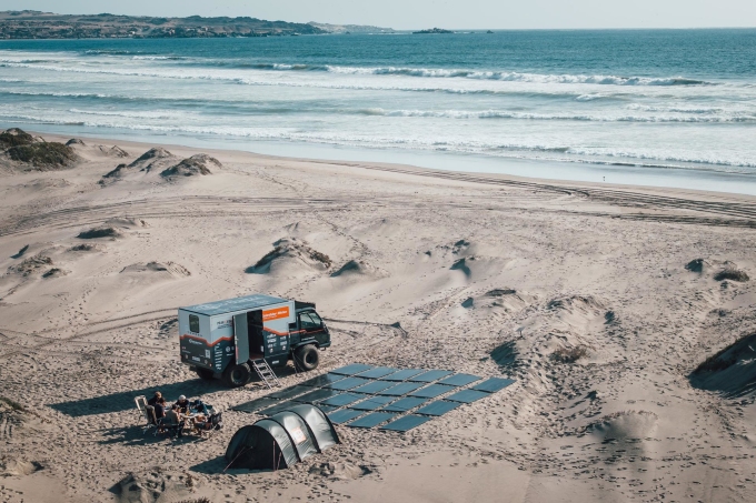 The Peak Evolution team uses a combination of rooftop and ground-based solar panels to power their electric trucks. Photo: Gebrüder Weiss/Anna Pocinska