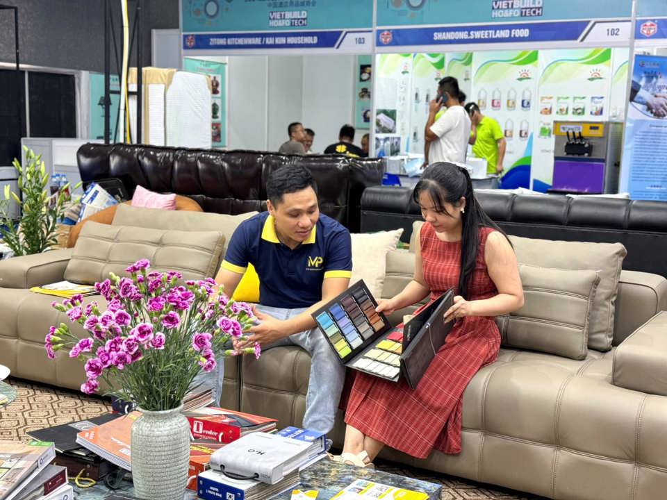 People visit a booth at the exhibition.