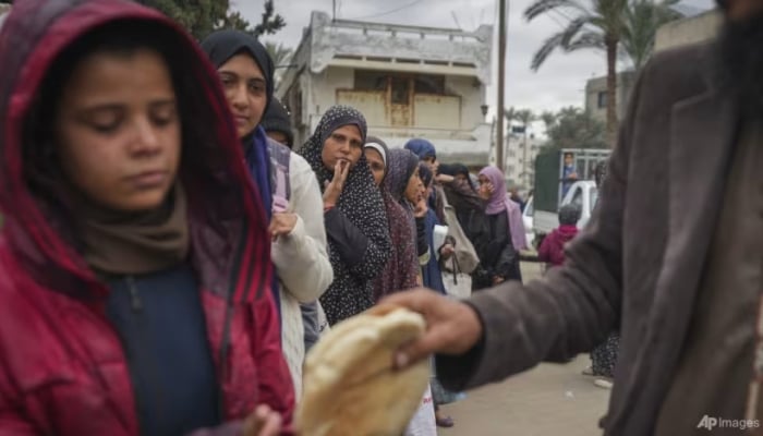 Gaza women and children forage for food in garbage heaps