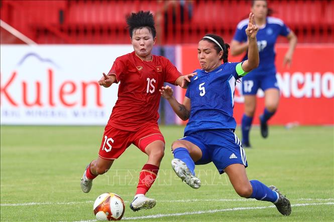 Philippines defender Hali Candido Long (5) tries to block Bich Thuy's (15) dribble.