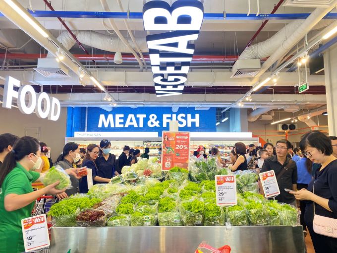 Customers shop at Win's vegetable counter. Photo: Masan