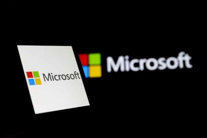 Microsofts logotyp visas på laptopskärm, 23 mars. Foto: AFP