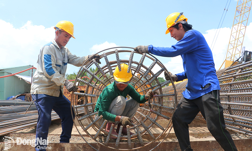 Workers constructing Nhon Trach bridge, part of project 1A, Tan Van - Nhon Trach section, Ring Road 3 project - Ho Chi Minh City
