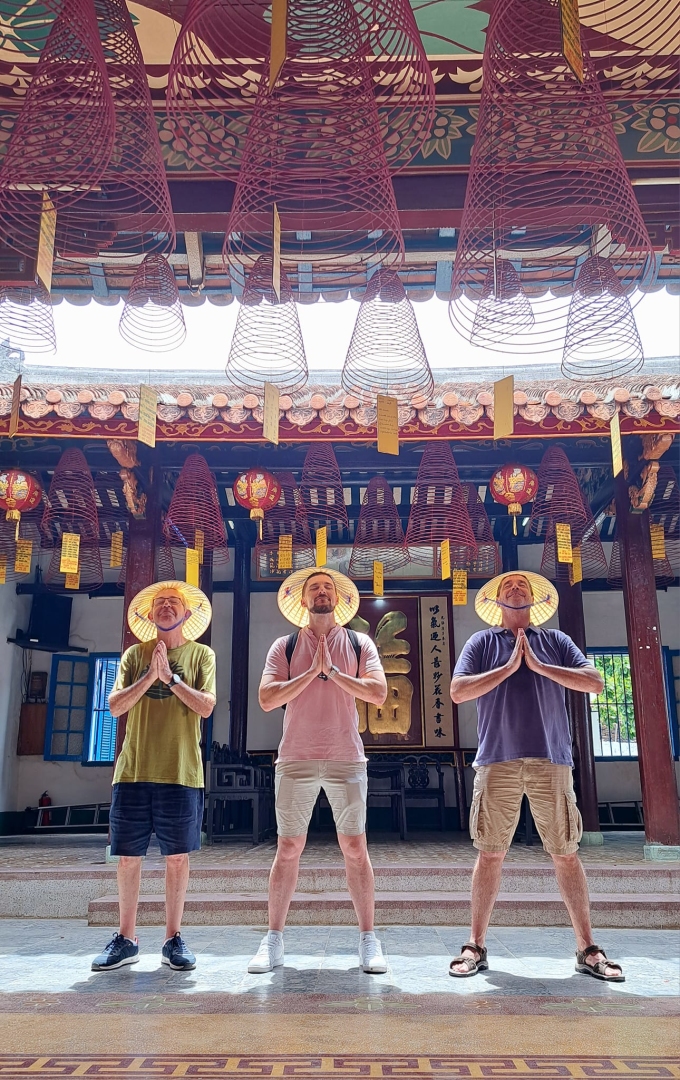 Spanish tourists wearing conical hats take souvenir photos in Vietnam during their trip in late September. Photo: Charlie Vietnam