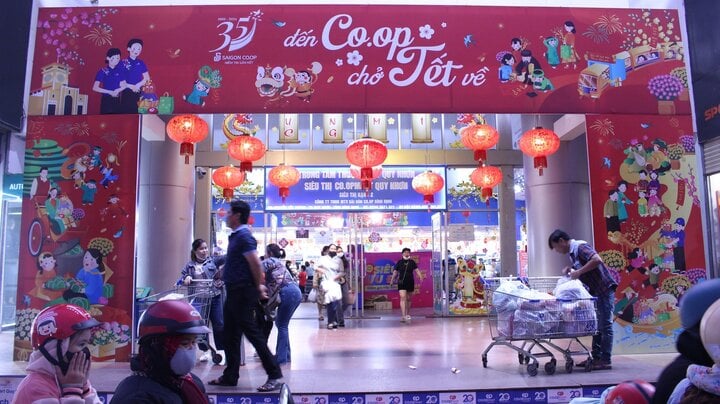 The supermarket is lit up until late at night to serve people shopping for Tet.