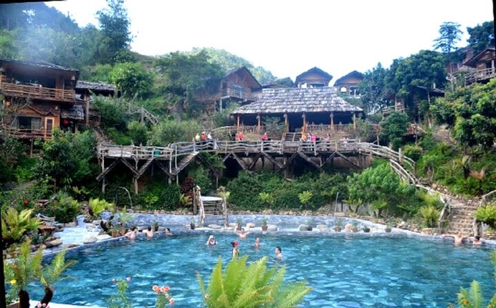 Tourists relax in hot mineral pools in Tram Tau district.