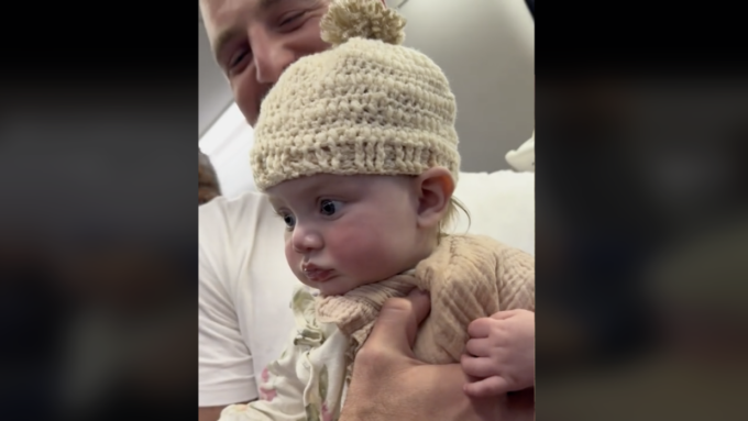 Baby Romey wears a hat knitted by Rubin on the plane. Photo: FOX 47 News