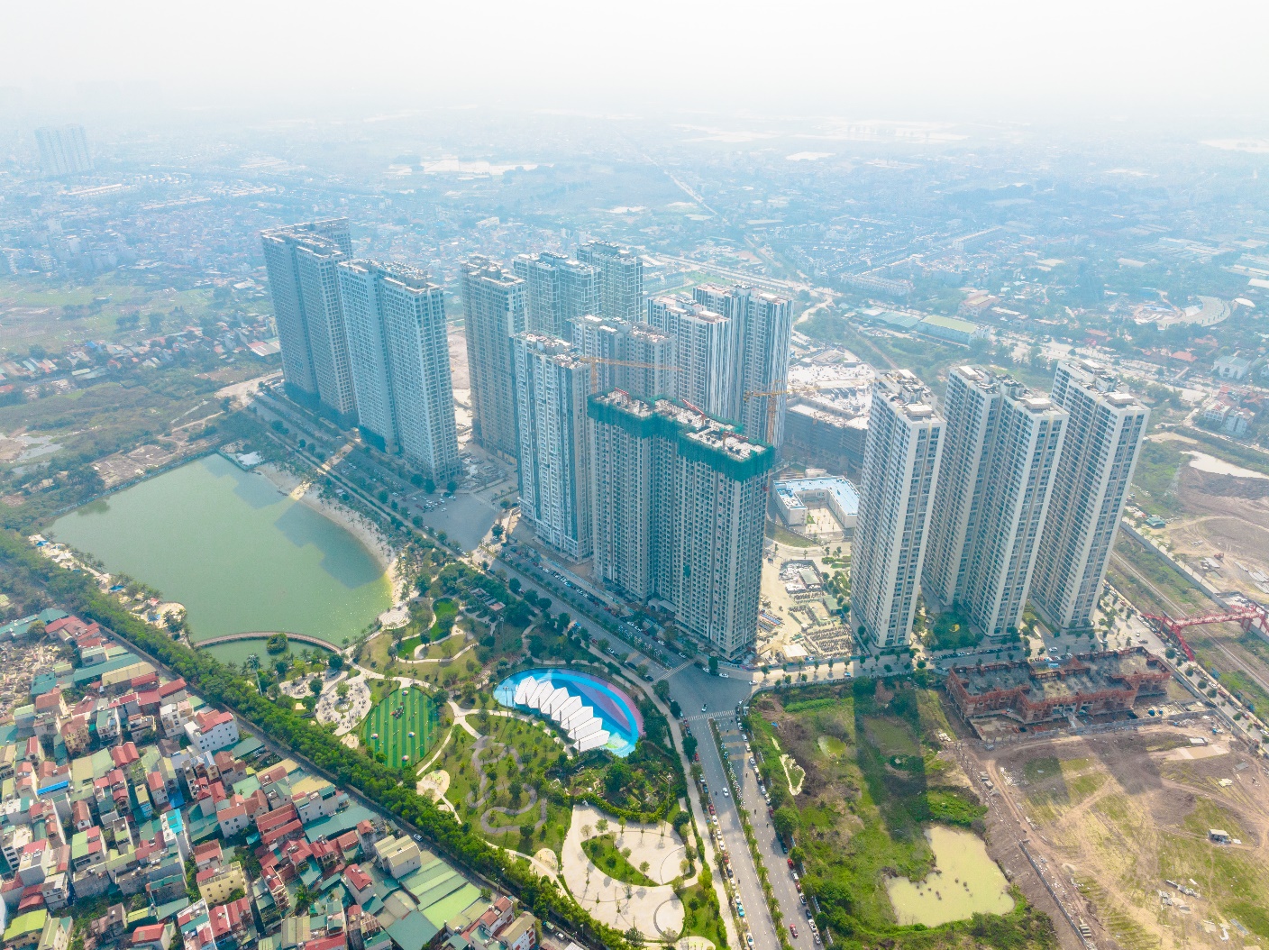 A group of tall buildings next to a body of water  Description automatically generated