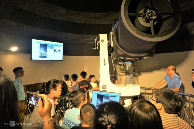 Tourists view images of galaxies captured by optical telescopes. Photo: Thao Chi