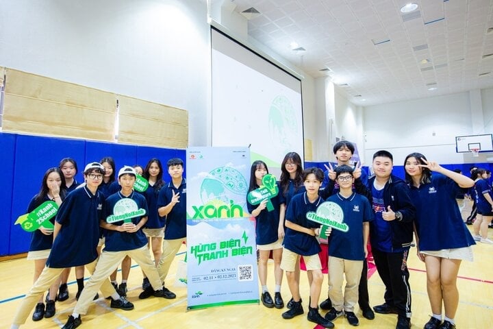 Students happily check in with the standee of the Green Voice contest.