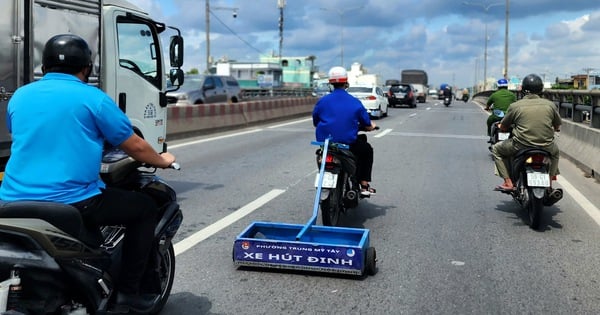 Equipo de succión de clavos en la autopista 1, sección que pasa por el paso elevado de An Suong