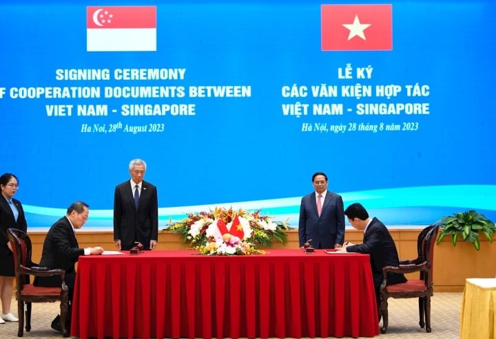 นายกรัฐมนตรี Pham Minh Chinh และนายกรัฐมนตรี Lee Hsien Loong แห่งสิงคโปร์ เป็นสักขีพยานในการลงนามหนังสือแสดงเจตจำนงในการดำเนินการต่อตามบันทึกความเข้าใจว่าด้วยความร่วมมือภายใต้มาตรา 6 ของข้อตกลงปารีส (ภาพ : นู๋ยุ้ย)