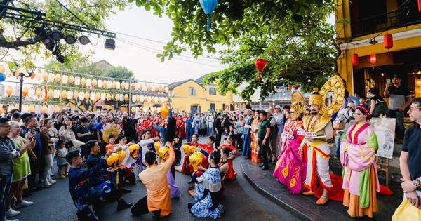 Tourists enjoy the 'Lantern Dance' on the streets of Hoi An