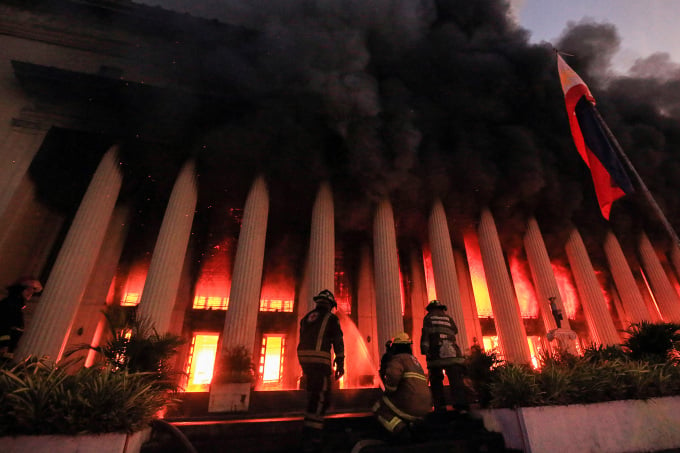 Firefighters put out a fire at the Manila Central Post Office in the Philippines early on May 22. Photo: AFP