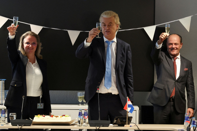 Far-right politician and PVV party leader Geert Wilders (center) raises his flag in celebration at the Dutch parliament after elections in The Hague on November 23. Photo: Reuters