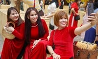 Ho Chi Minh City people in traditional long dresses go to Ong Do Street for early spring fun