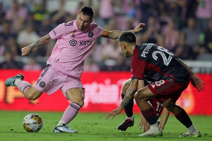 Messi sút bóng trước hai cầu thủ Toronto FC, trước khi rời sân trong trận đấu hôm 20/9. Ảnh: USA Today