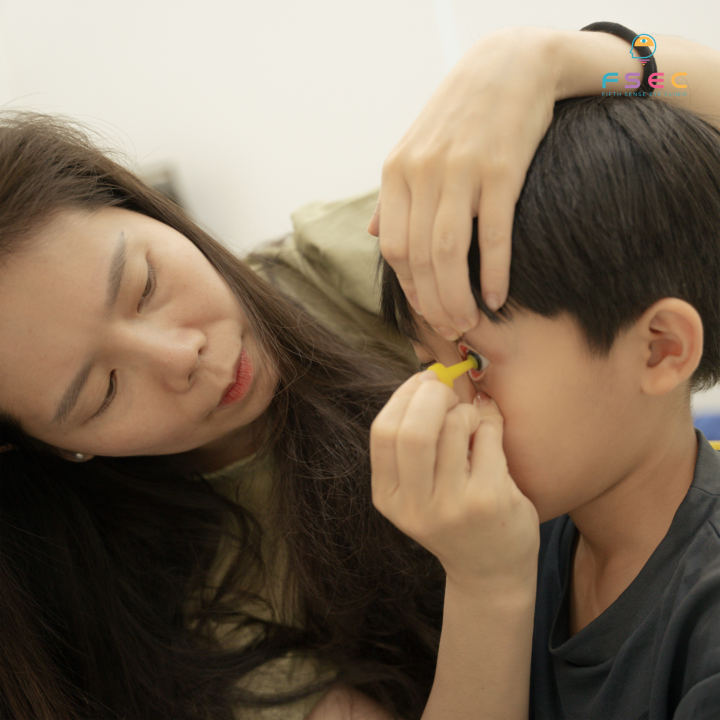 Children practice wearing and removing Ortho-K with their parents.