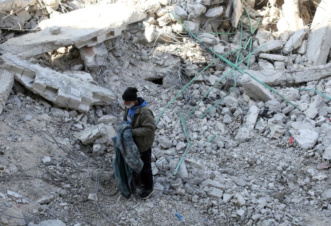 A man stands on the rubble of what used to be his home in Jableh, Syria, February 12. Photo: Reuters