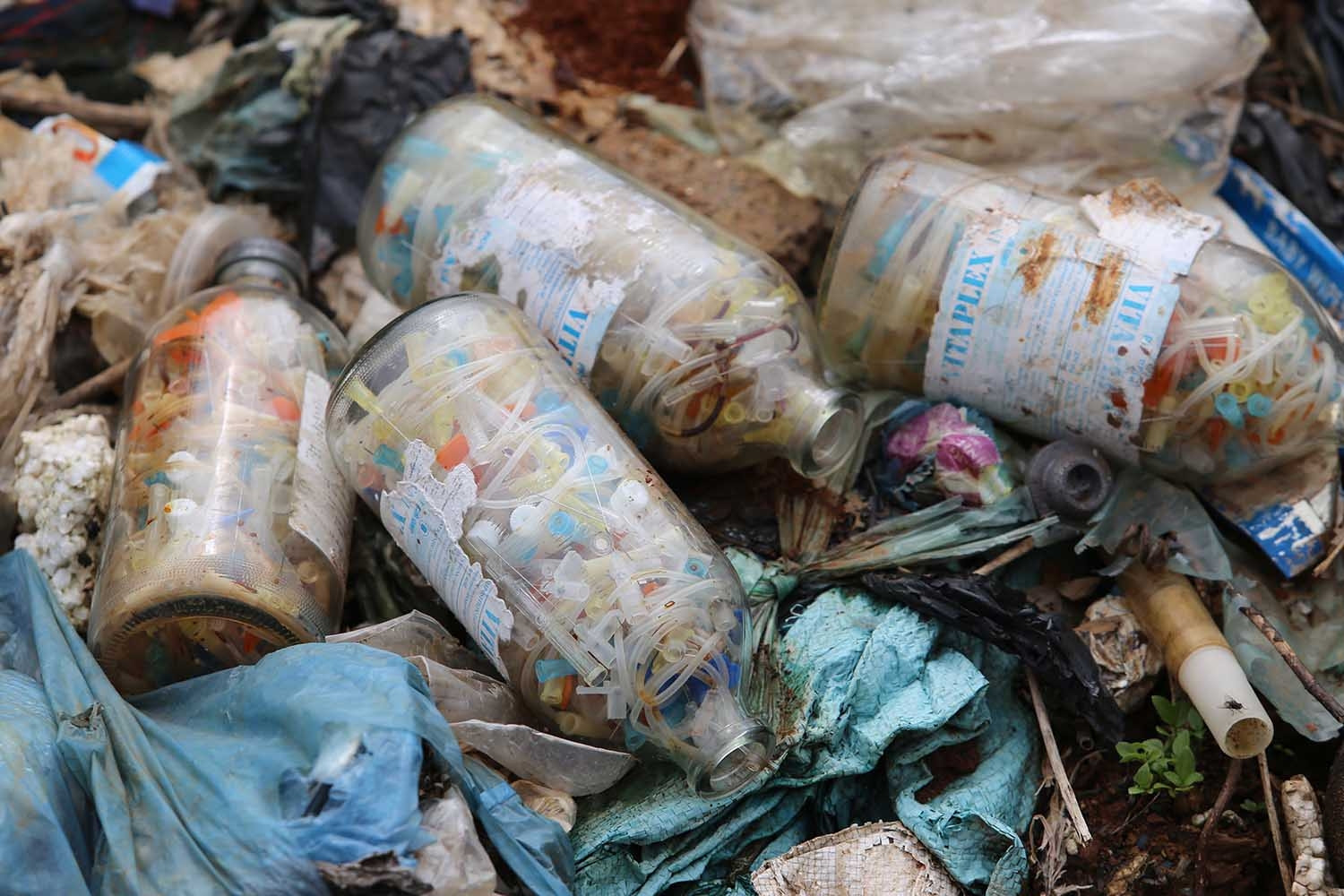 Blood-red needles mixed in a mountain of garbage in Moc Chau