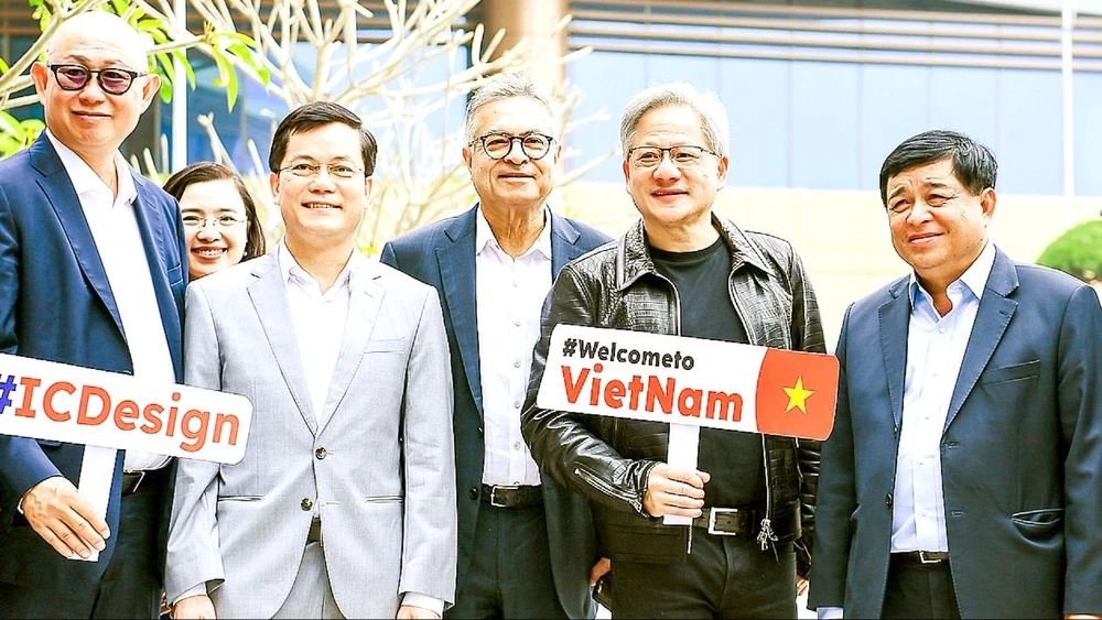 Minister of Planning and Investment Nguyen Chi Dung (right cover) takes a souvenir photo with Nvidia Corporation Chairman Jensen Huang. Photo: NGUYEN BAO